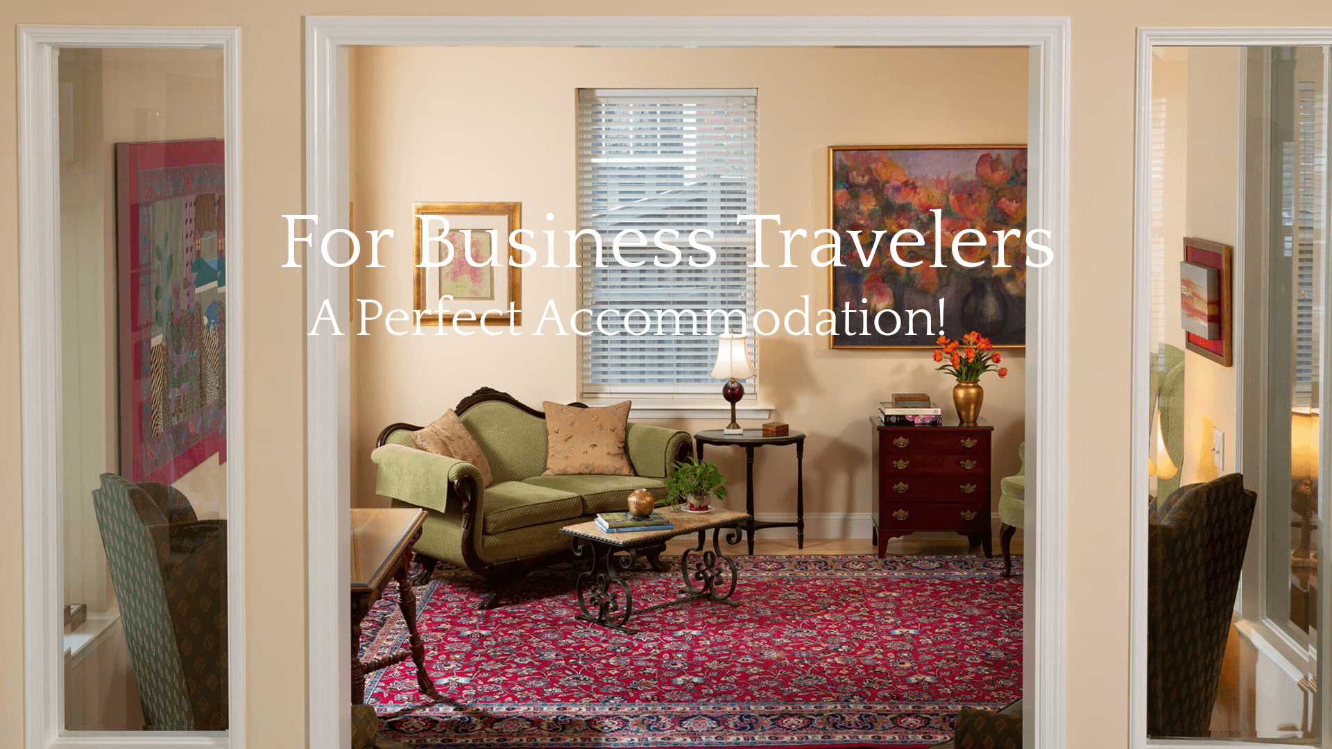 Cozy living room designed for business travelers, featuring a green sofa, coffee table, and artwork.