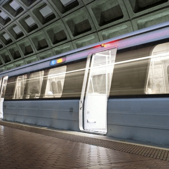 A subway train with an open door at a modern station.