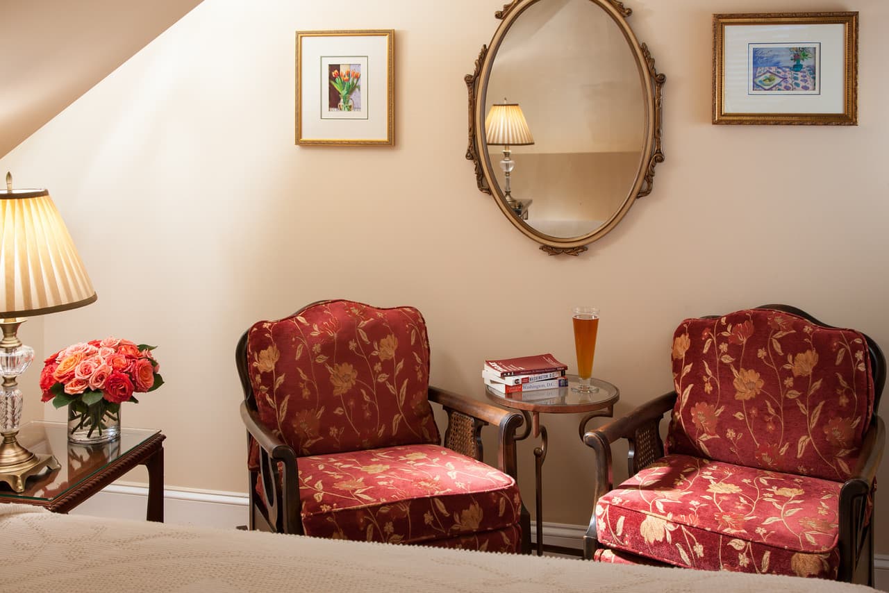 sitting area with a glass of beer and vase of flowers