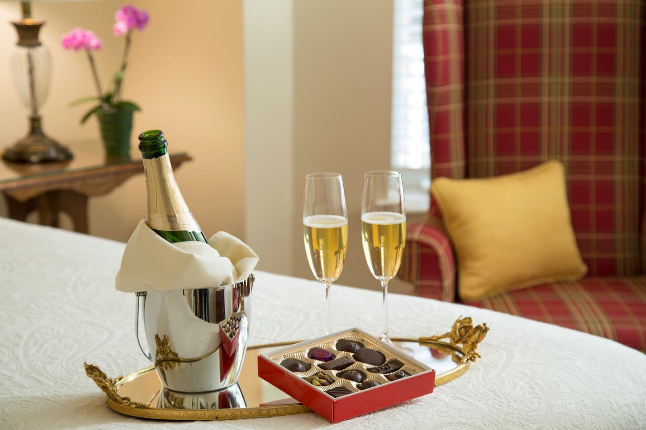 a chilled bottle with two glasses and fine chocolates